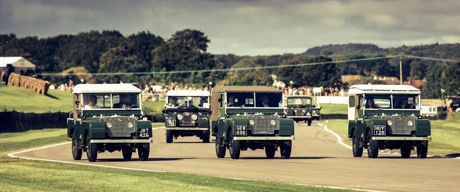 A group of several green Land Rover.