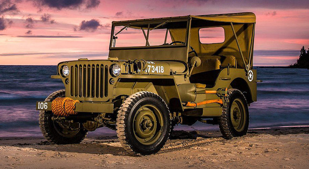 A jeep Willys on a beach.