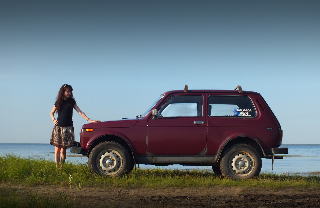 A girl and a violet Lada Niva.