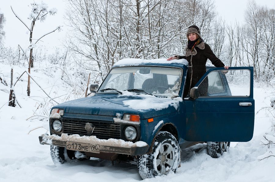 A girl and a blue Lada Niva.