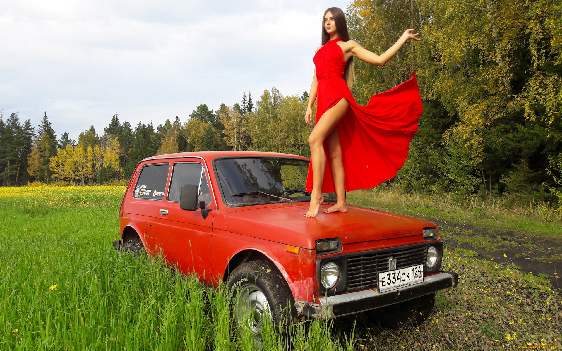 A girl on a Red Russian Lada Niva.