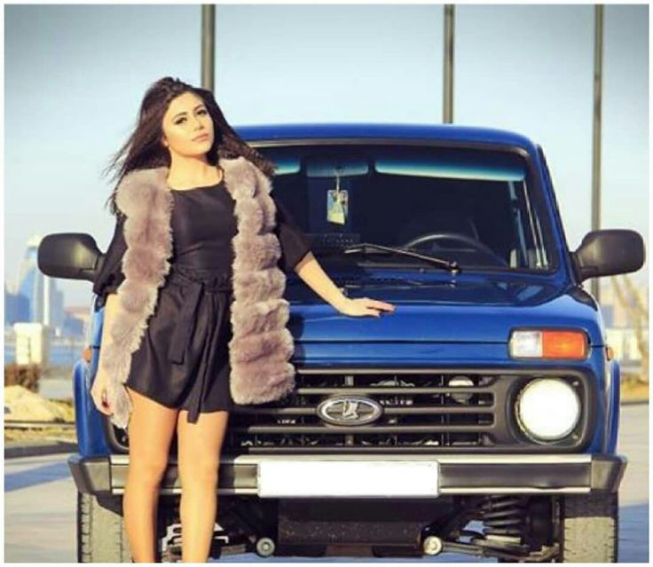 A girl and a blue Lada Niva.
