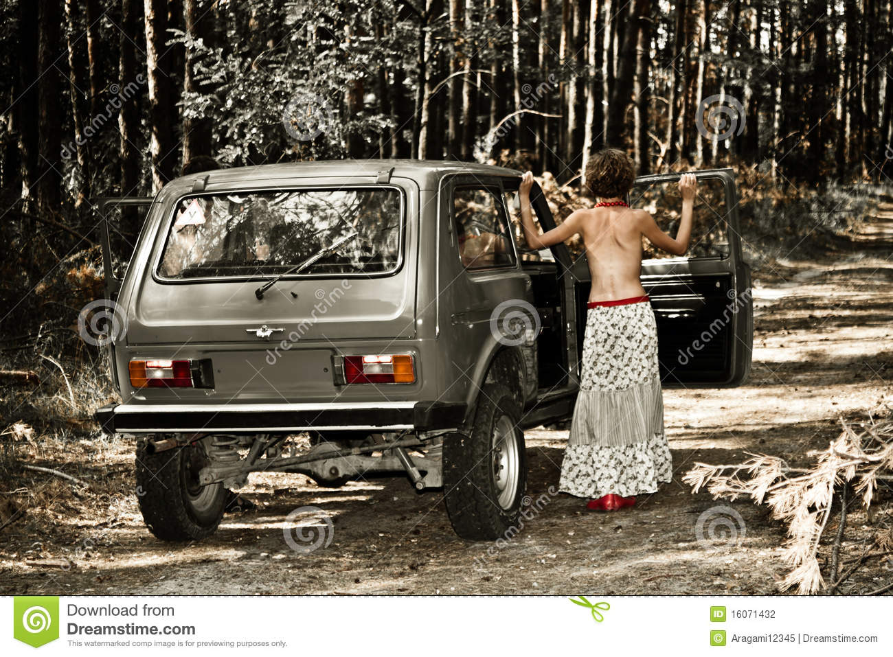 Vintage topless girl in front of a Lada Niva.