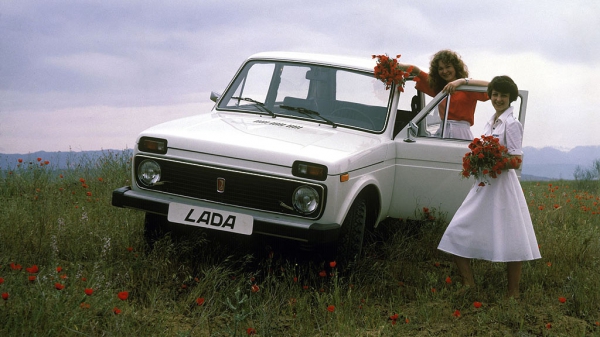Two girls and a white Lada Niva.