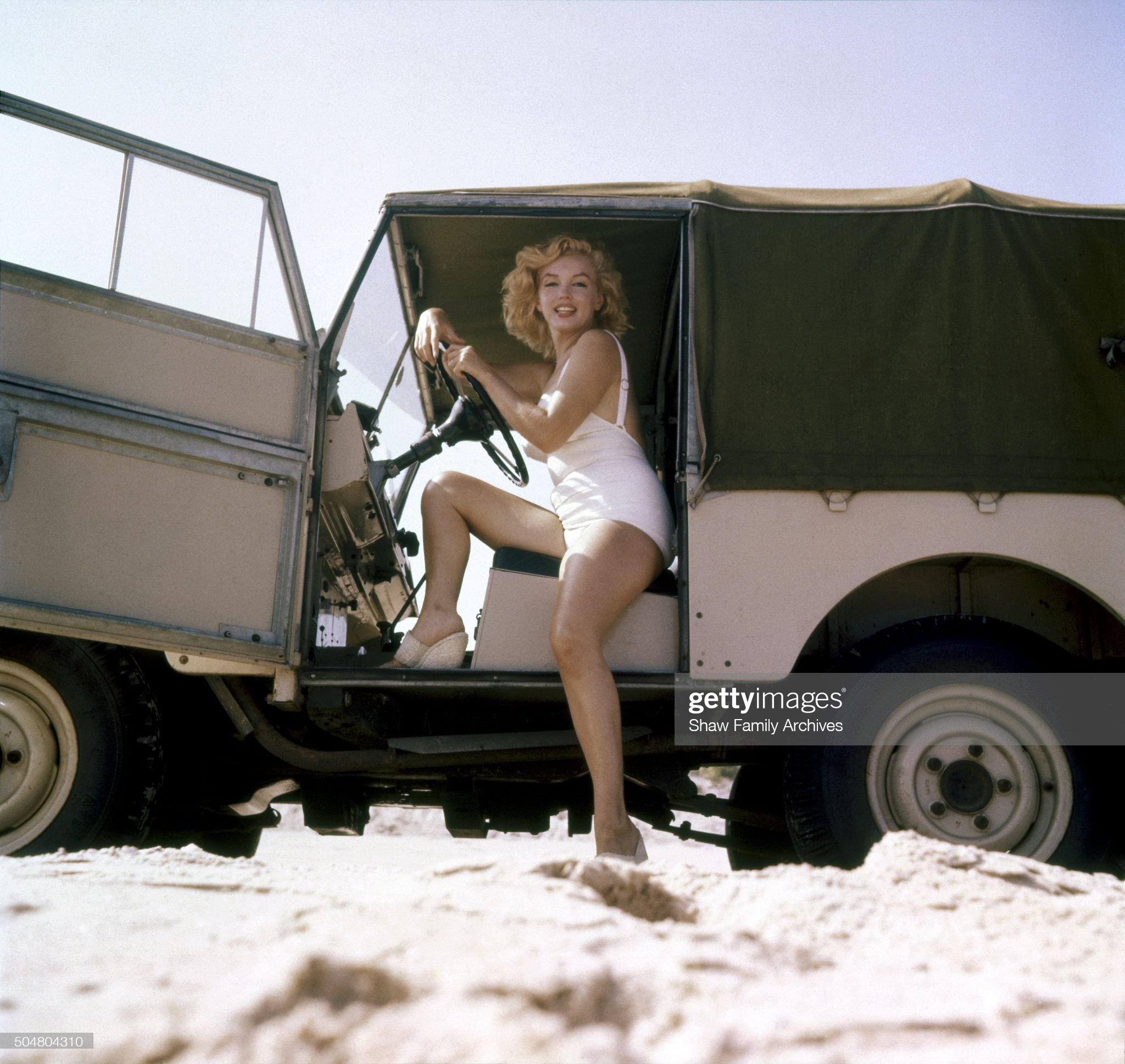 Marilyn Monroe sits in a Land Rover on the beach in 1957 in Amagansett, New York. 