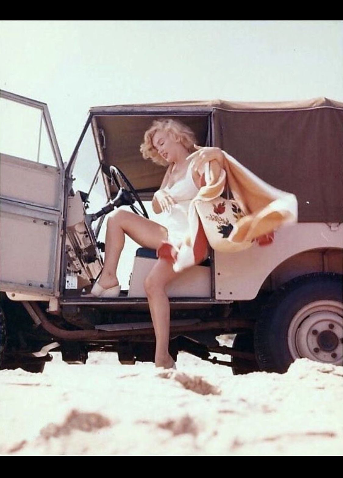 Marilyn Monroe sits in a Land Rover on the beach in 1957 in Amagansett, New York.