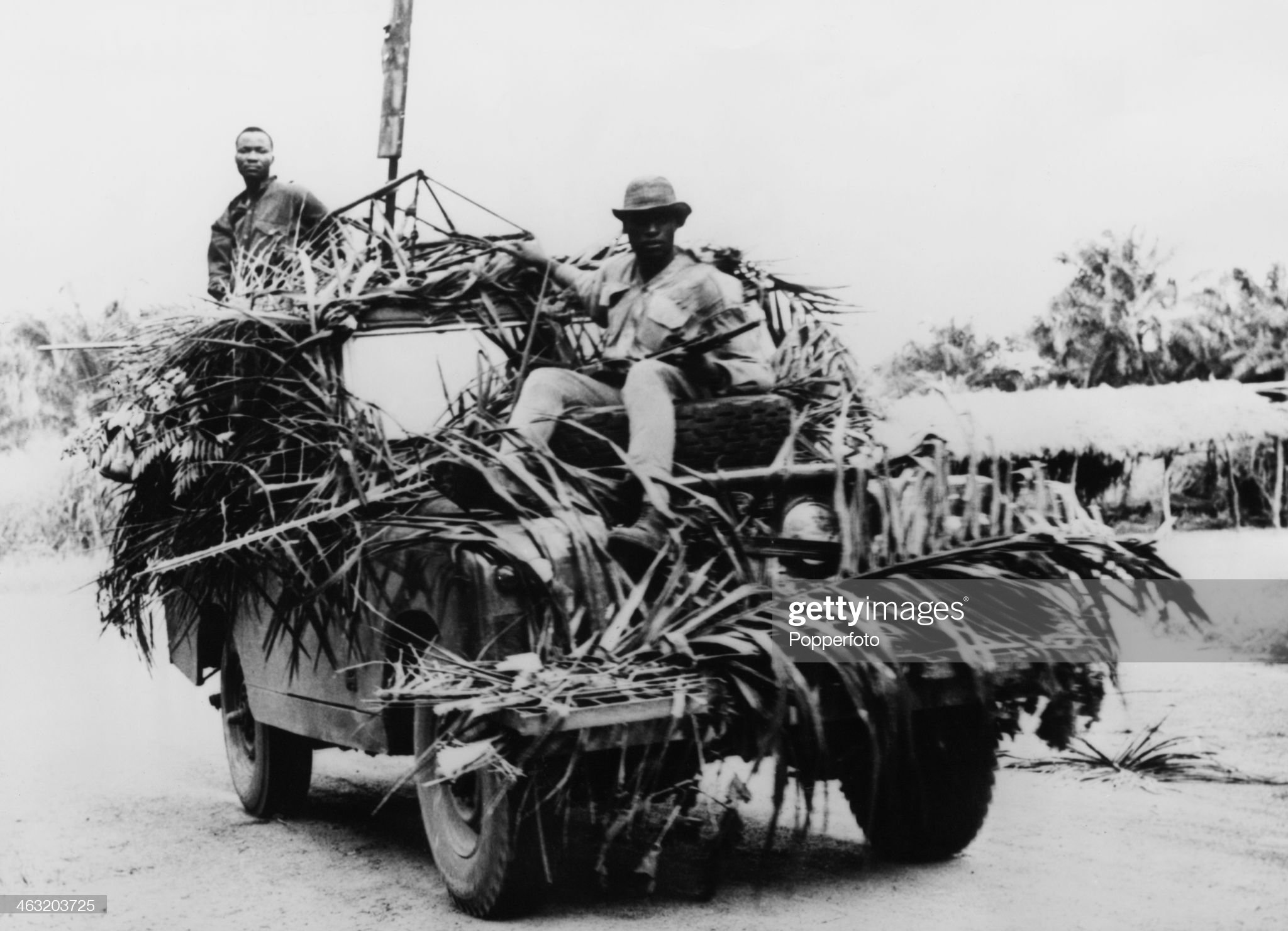 Government troops riding on a camouflaged Land Rover in a search for rebel troops of the breakaway region of Biafra, during the Nigerian Civil War, also known as the Biafran War, Nigeria, 27th August 1967.