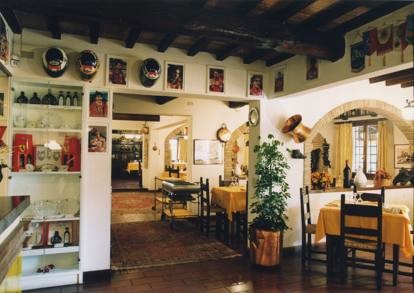 A former farmhouse and stable, the Cavallino restaurant was simple and rustic, with high-backed wooden chairs at square tables, exposed wooden roof beams and whitewashed walls. 