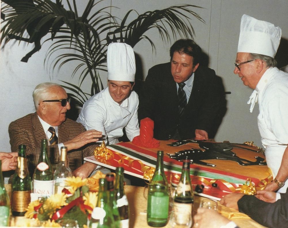 Enzo Ferrari’s 90th birthday. Il Commendatore and Giuseppe Neri in front of a cake depicting the prancing horse. 