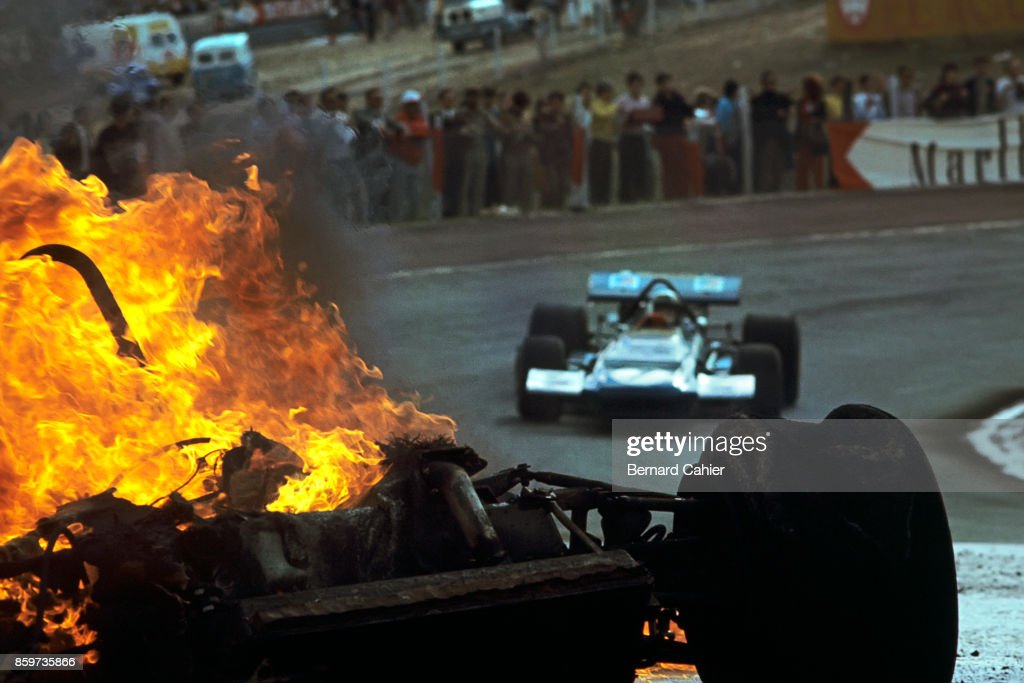 Jackie Stewart, March-Ford 701, GP of Spain, Jarama, April 19, 1970, on his way to victory passes by the flaming debris of the cars of Jackie Ickx and Jackie Oliver. 