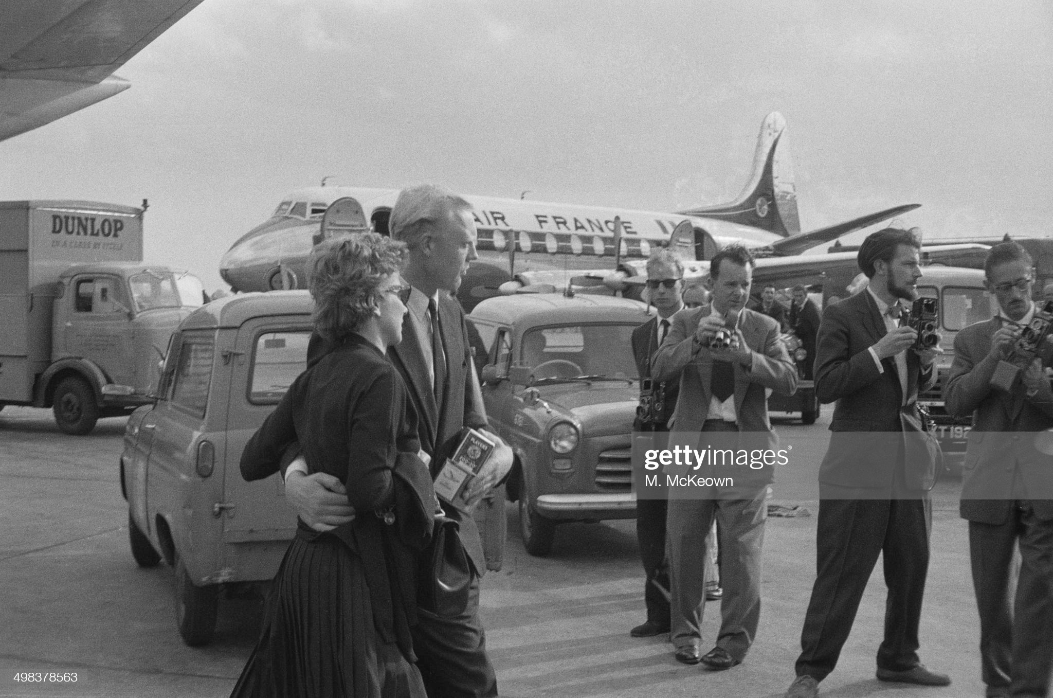 Mike Hawthorn arrives at London Airport with Louise Collins, the wife of fellow racing driver Peter Collins, UK, 04th August 1958. Collins had been killed the day before.