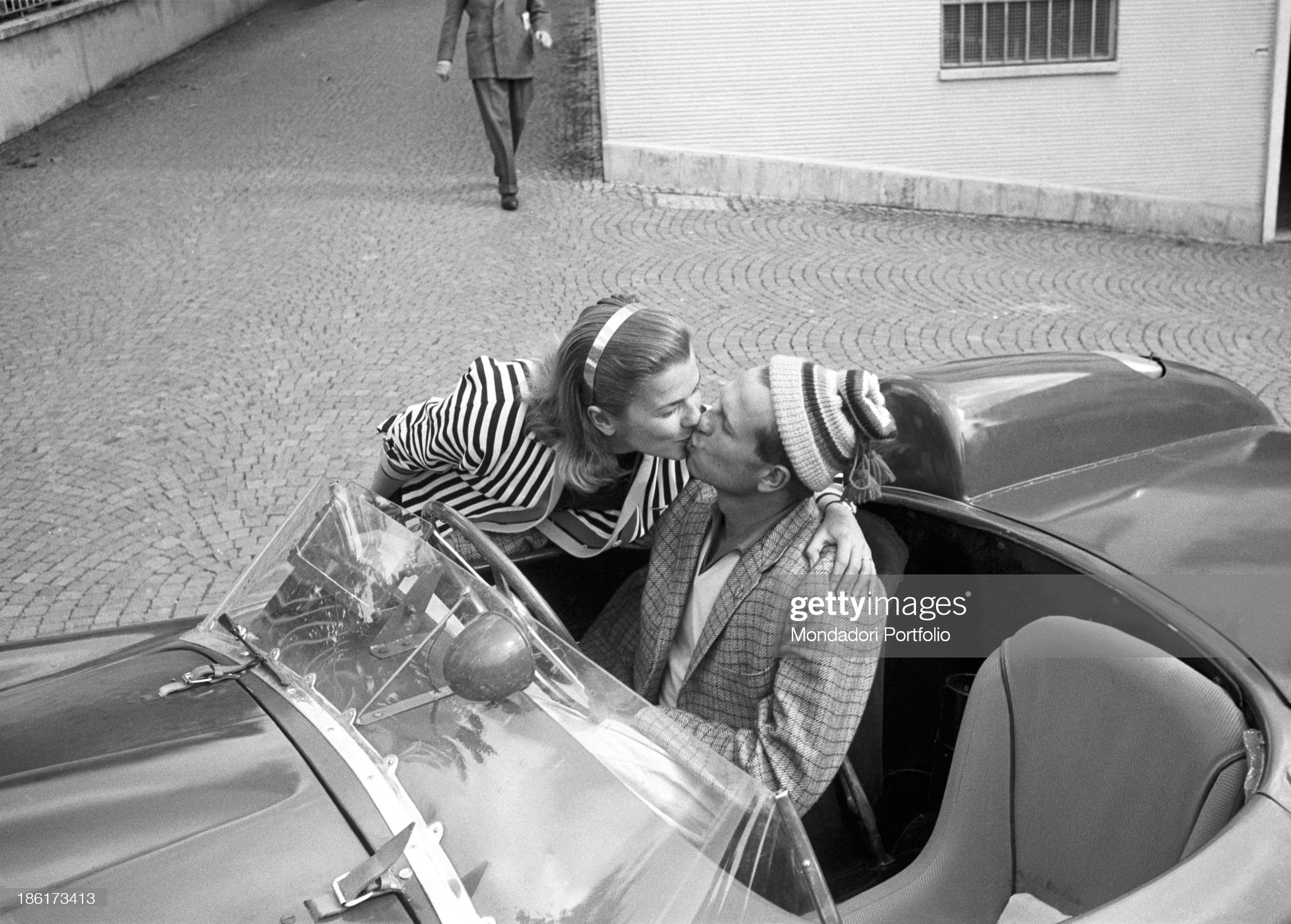 Peter Collins kissing his American wife Louise Collins at the Mille Miglia Automobile Race. Italy, May 1957. 