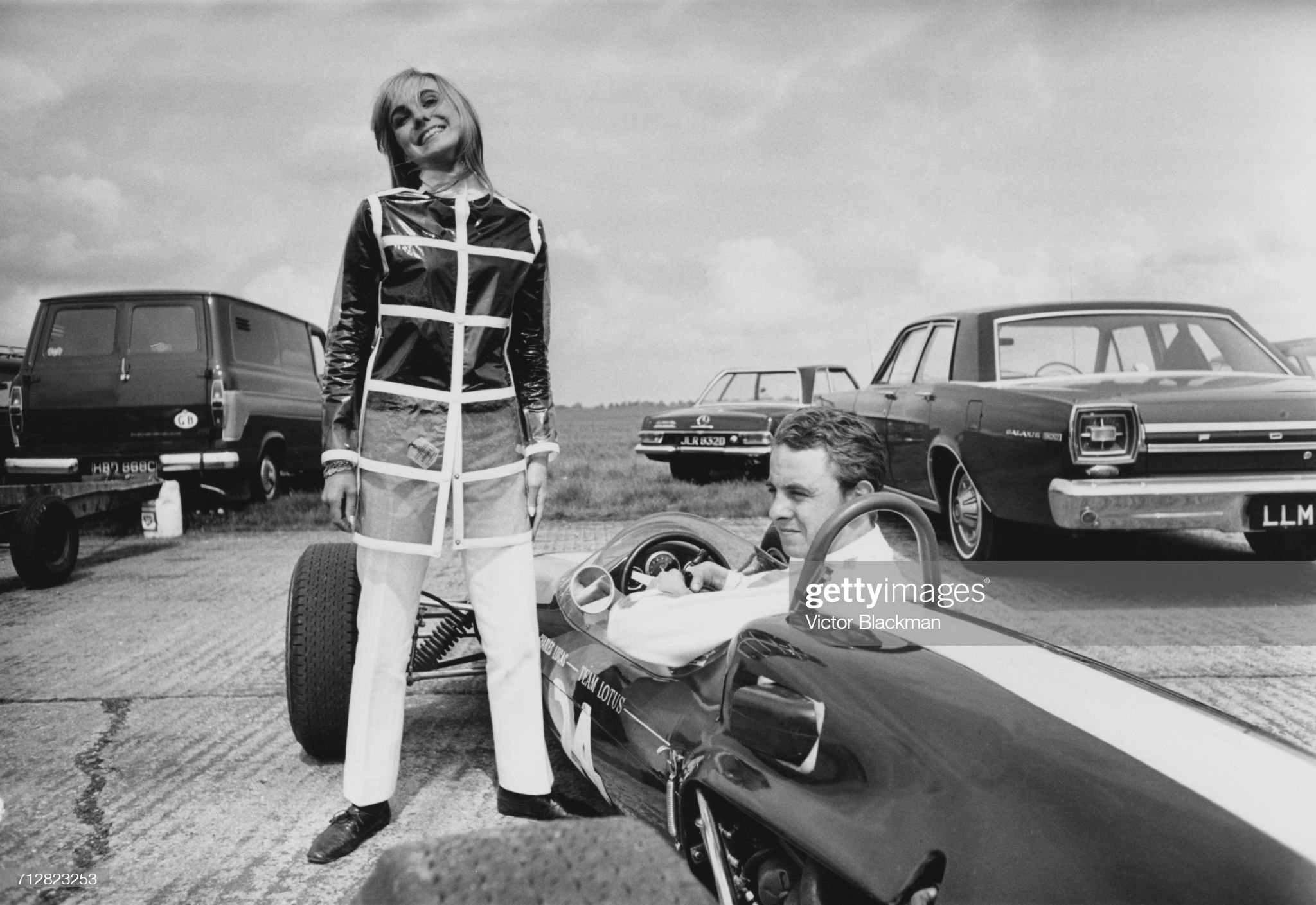 Piers Courage sits aboard the n.24 Lotus 41 as his wife Lady Sarah Curzon stands beside him.