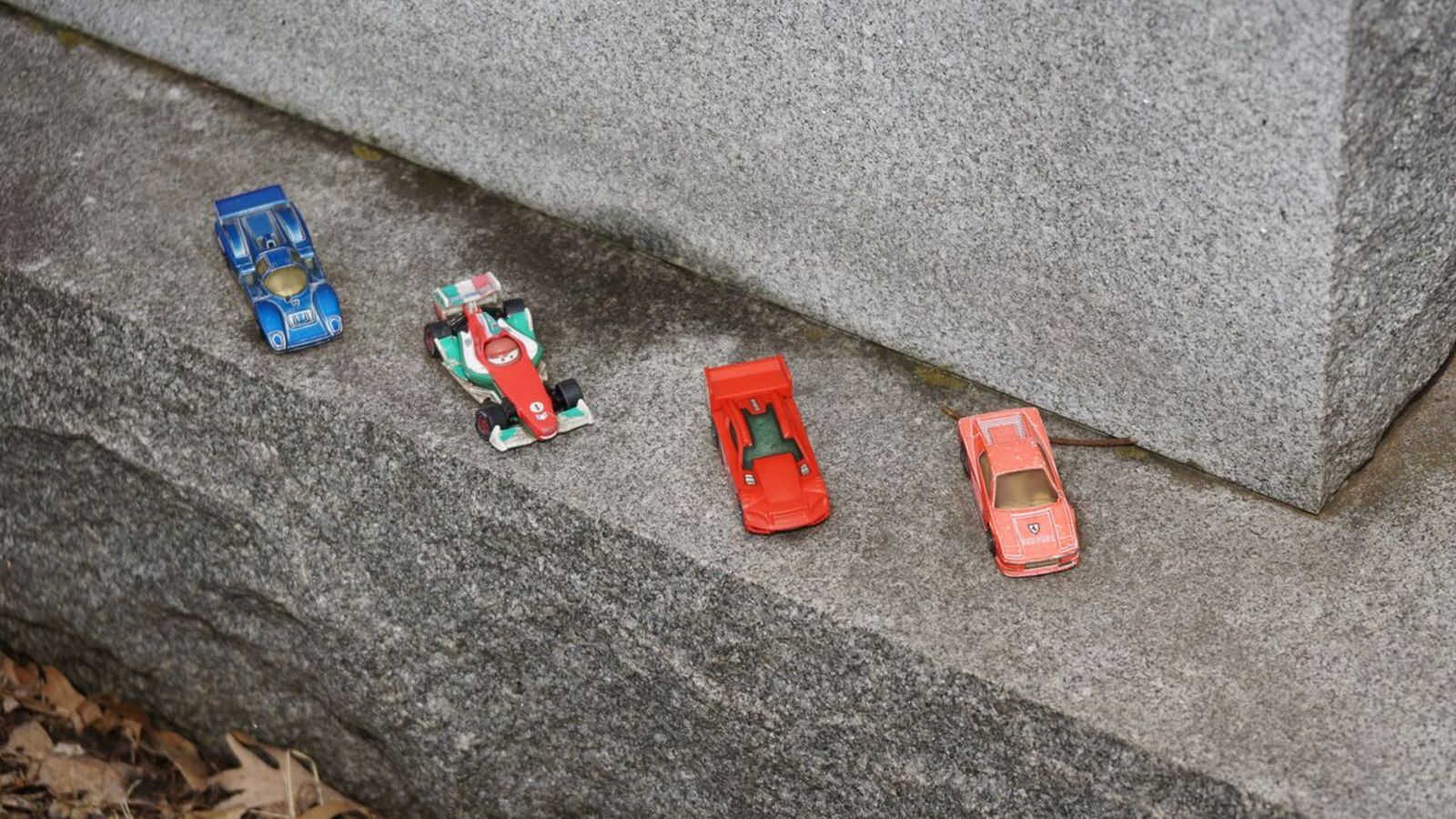Toy cars at the gravesite of Mark Donohue.