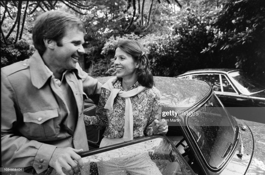 Mark Donahue with his wife, socialite model Eden White and the Mini he gave her, his black Porsche in background, April 02, 1975. 