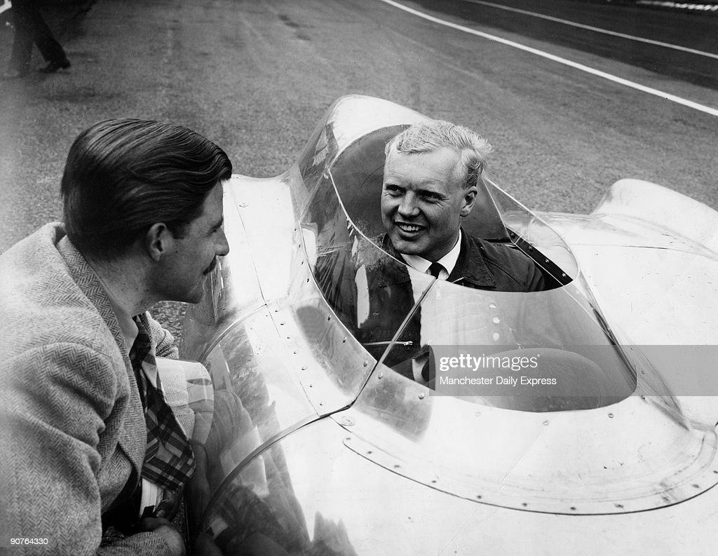 Mike Hawthorn in the cockpit of a Lotus Climax talking with Graham Hill on 12 April 1956. 