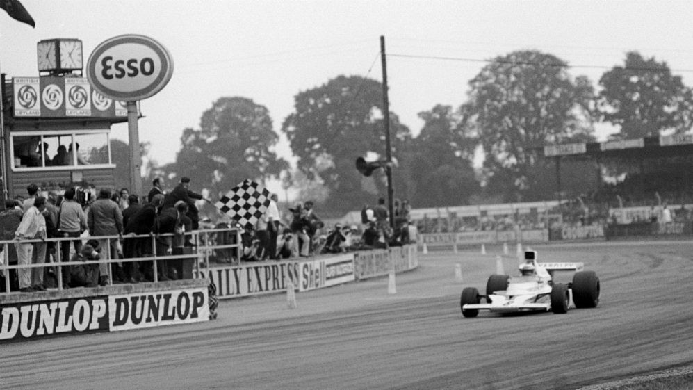 Peter Revson, USA, McLaren M23, celebrates his first GP win as he takes the chequered flag at the end of the race. 