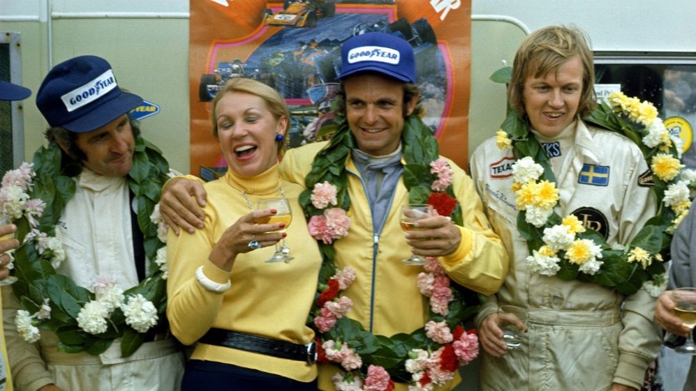 A Goodyear celebration following a 1-2-3 finish on their rubber (Left to Right): Denny Hulme (NZL), McLaren, third; first time race winner Peter Revson (USA), McLaren; Ronnie Peterson (SWE), Lotus, second. British Grand Prix, Silverstone, 1973. 
