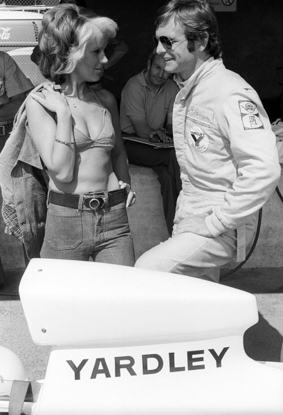 Peter Revson, McLaren, who retired from the race on the opening lap of the race with a broken clutch, talks with a visitor to the pits. Austrian GP, Osterreichring, 19 August 1973.