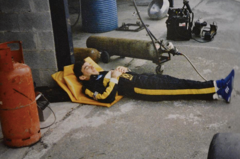 Ayrton Senna sleeping in the pits.