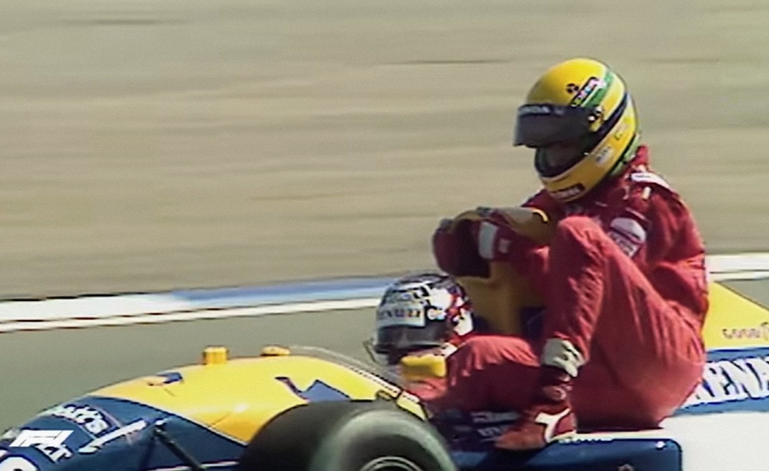 Ayrton Senna takes a lift from Nigel Mansell at the Silverstone GP in 1991.
