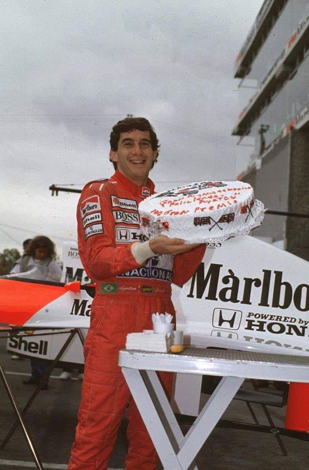 Ayrton Senna with a cake to celebrate his 100th Grand Prix start at the 1990 Mexican Grand Prix.