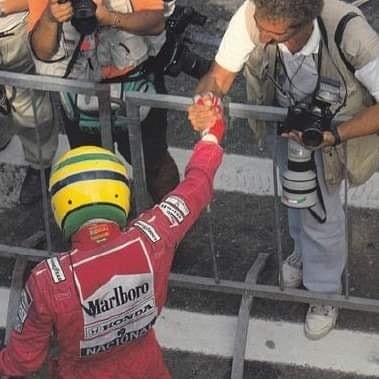 Ayrton Senna at imola, shaking the hand of Angelo Orsi, his favoutite photographer and friend.