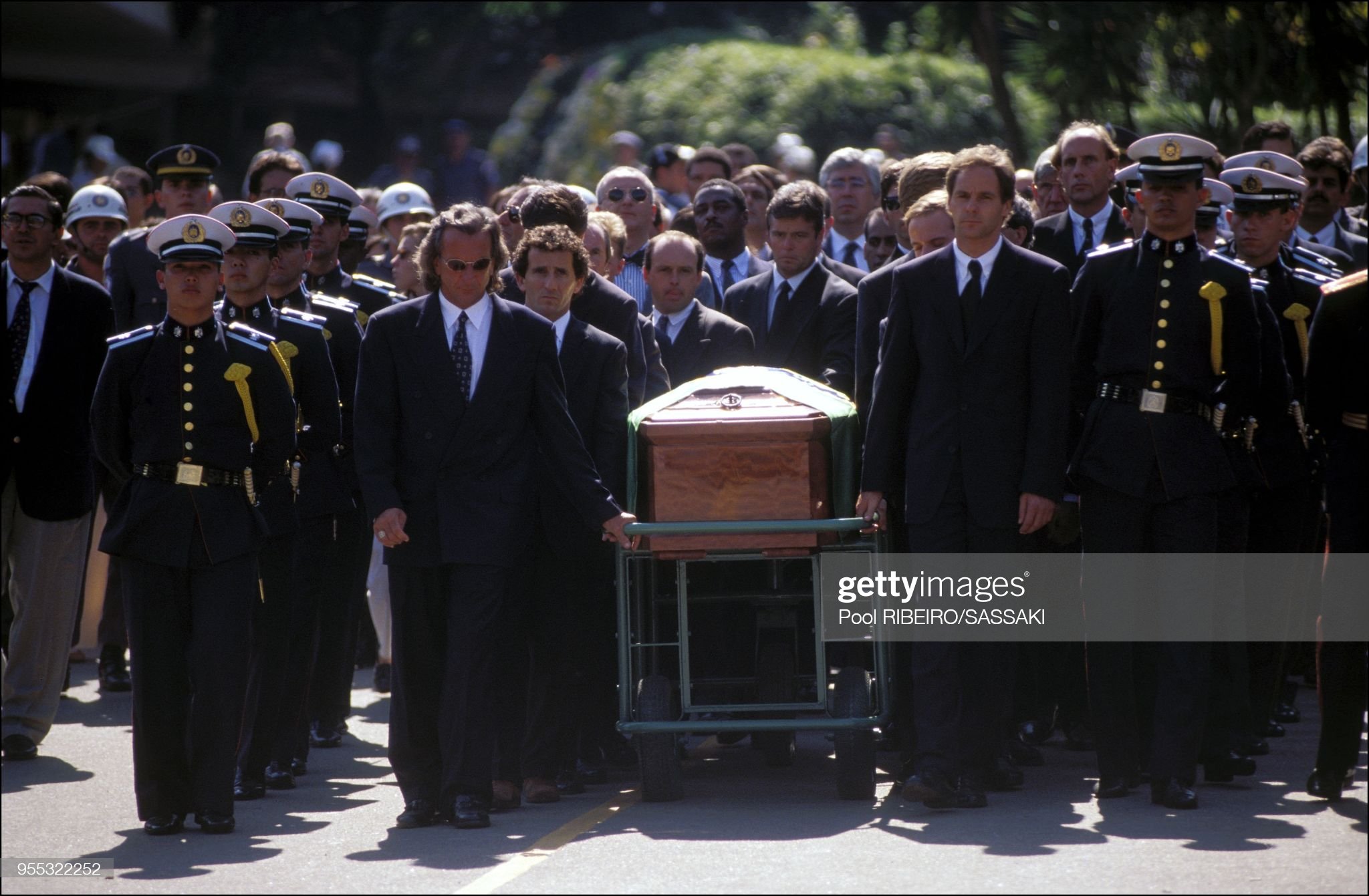 Emerson Fittipaldi, Alain Prost and Gerhard Berger next to the coffin of Ayrton Senna. 