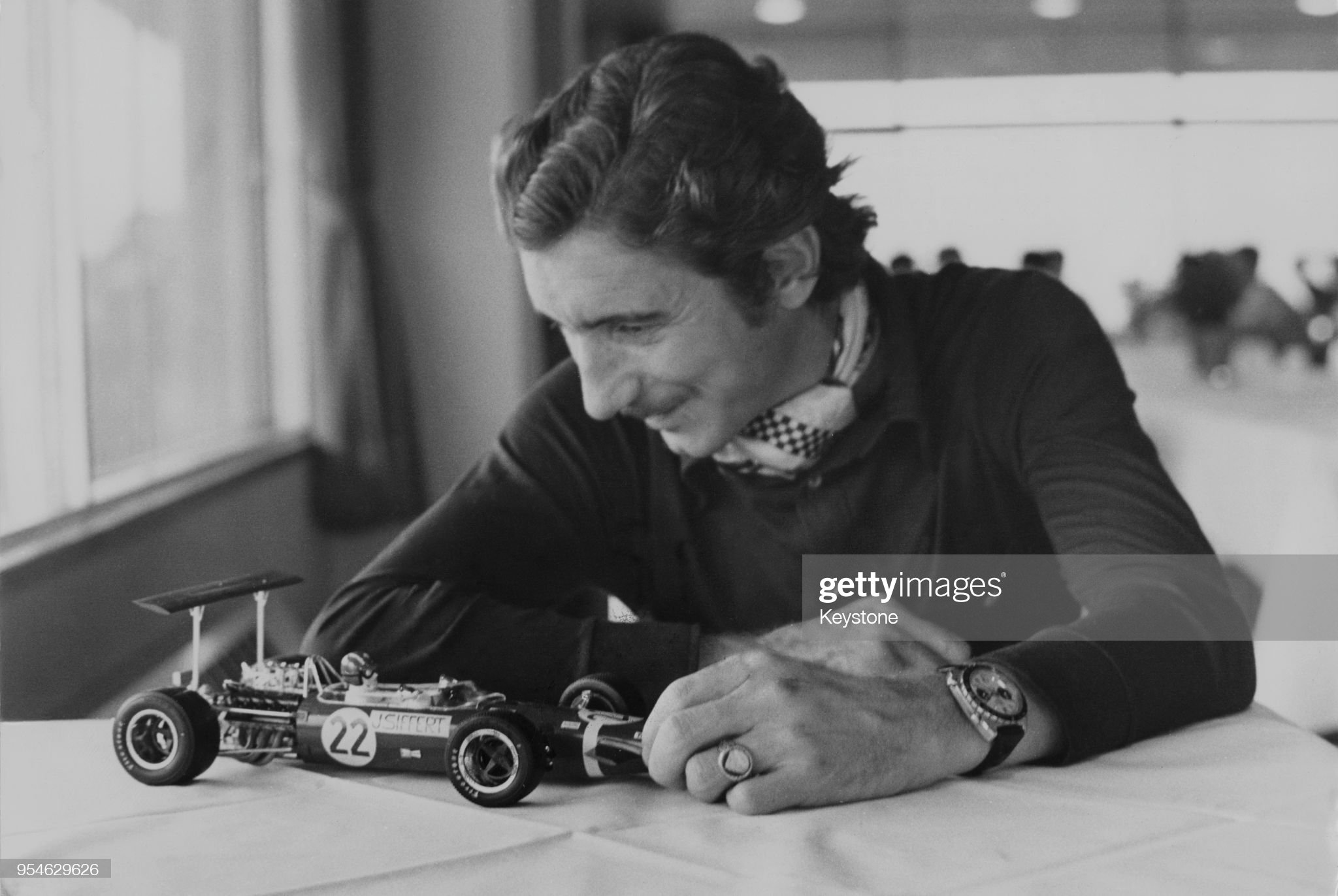 Jo Siffert examines a model of the F1 Lotus Ford racing car in which he won the British Grand Prix the year before, 1969.