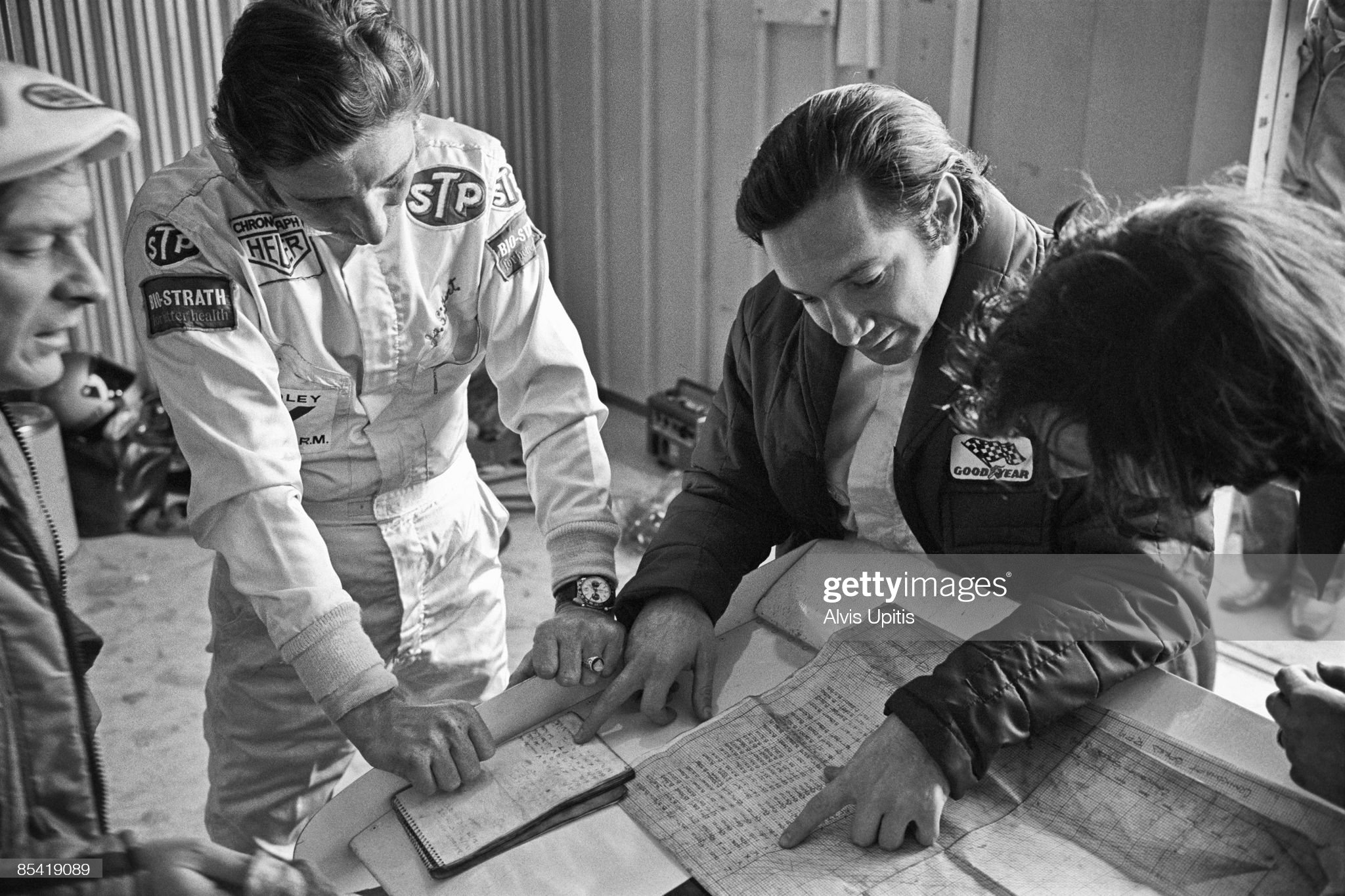 Pedro Rodriguez, right, studies gear charts with fellow Brabham driver Jo Siffert and mechanic.