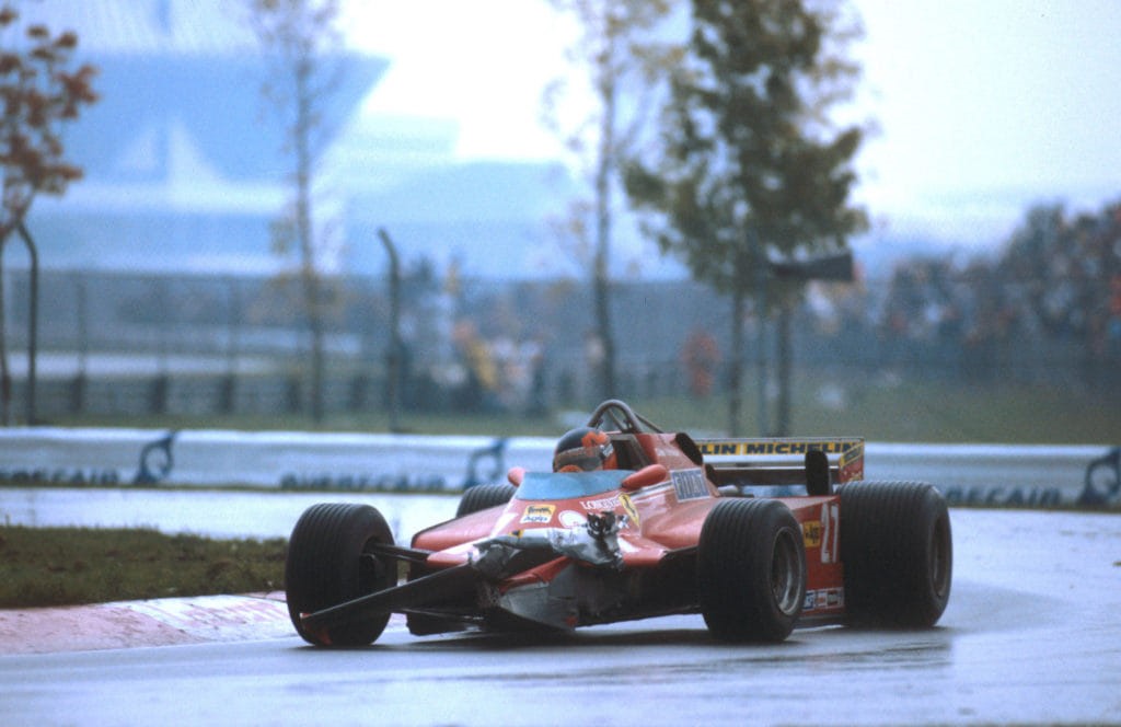 Gilles Villeneuve driving a Ferrari with a broken nose and wing.