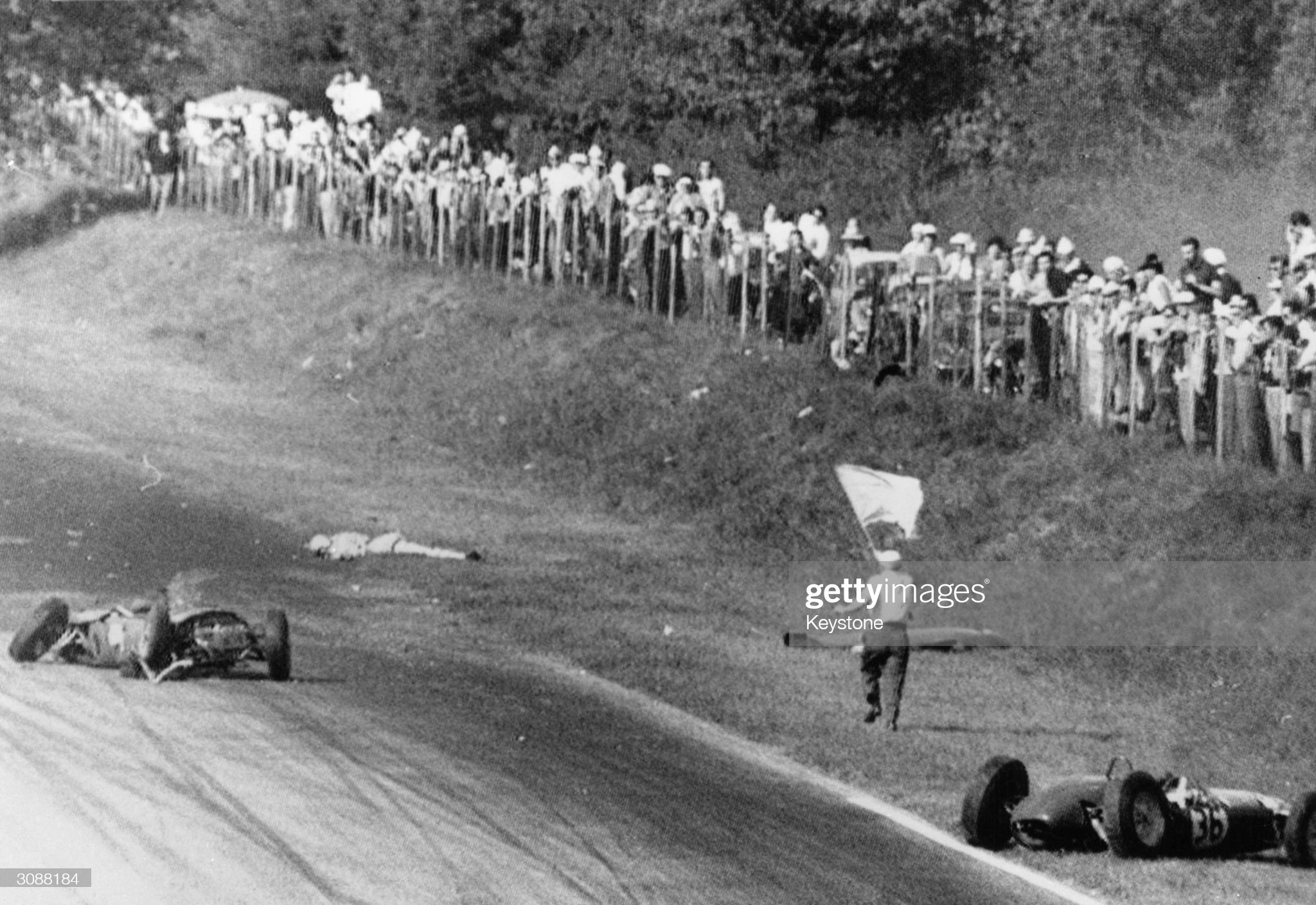 10th September 1961: the body of Wolfgang von Trips lies on the edge of the track at Monza with his wrecked car to the left. 