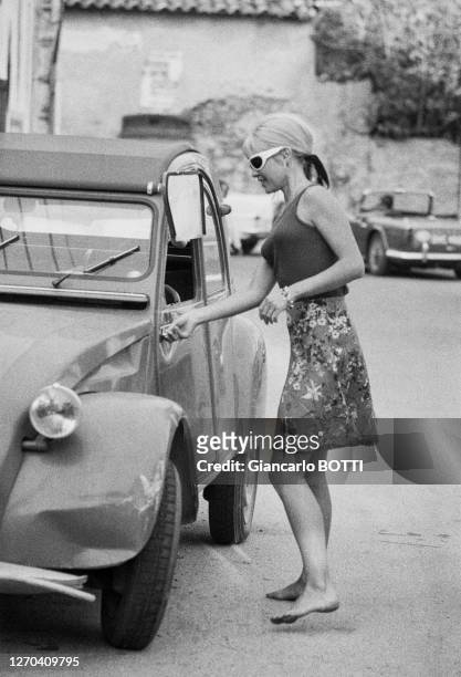 Brigitte Bardot gets into her 2CV Citroën in Saint-Tropez in August 1965. 