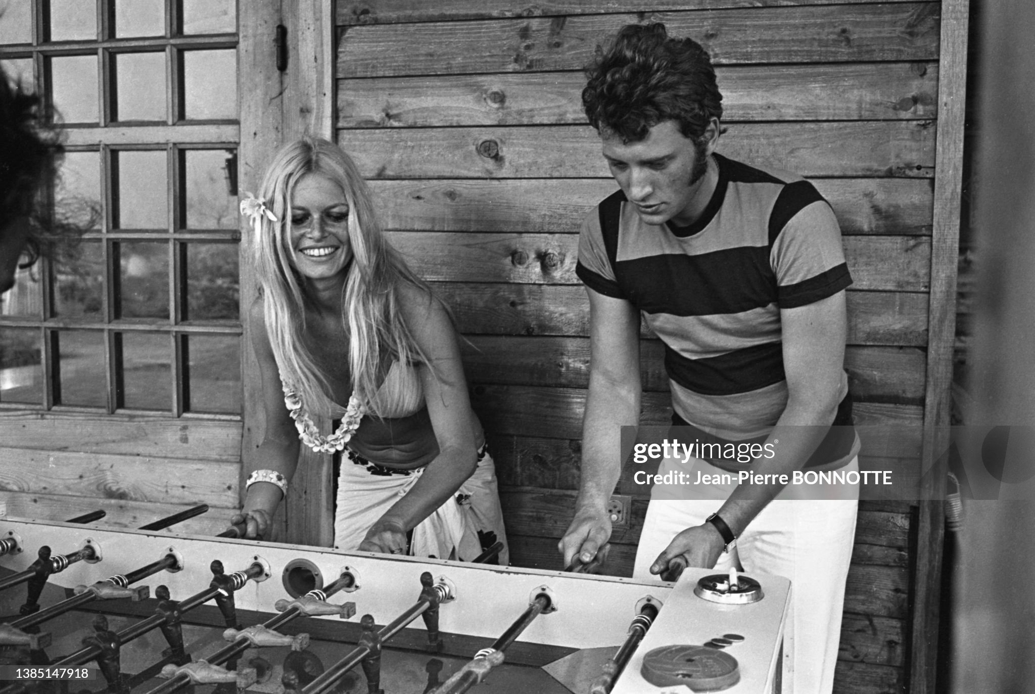 Brigitte Bardot in a bikini and sarong and Johnny Hallyday playing table football at the Epi-plage hotel in Saint-Tropez in August 1967. 