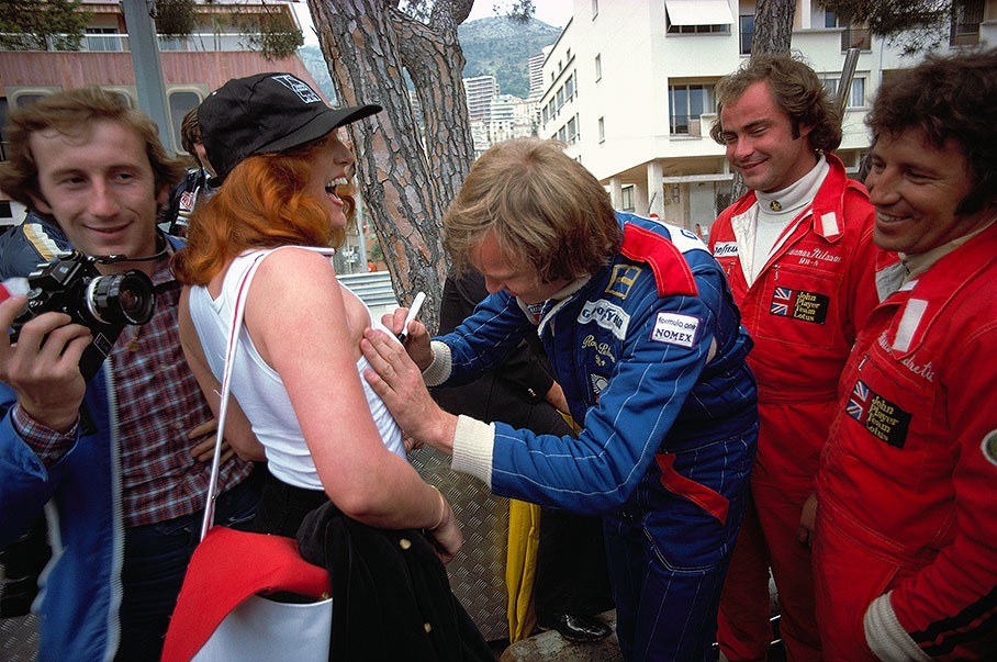 1977, Monte Carlo. Ronnie Peterson signs a fan's shirt, Lotus drivers Gunnar Nilsson and Mario Andretti watching the scene. 
