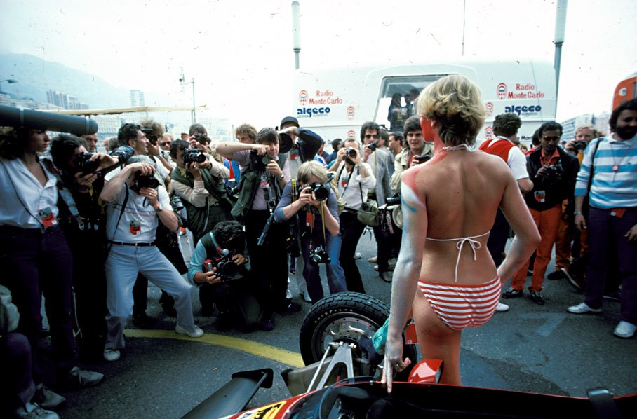 A body-painted promotional girl poses for the photographers with a Ferrari in 1983. 