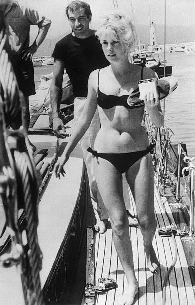 Catherine Deneuve in a black bikini.