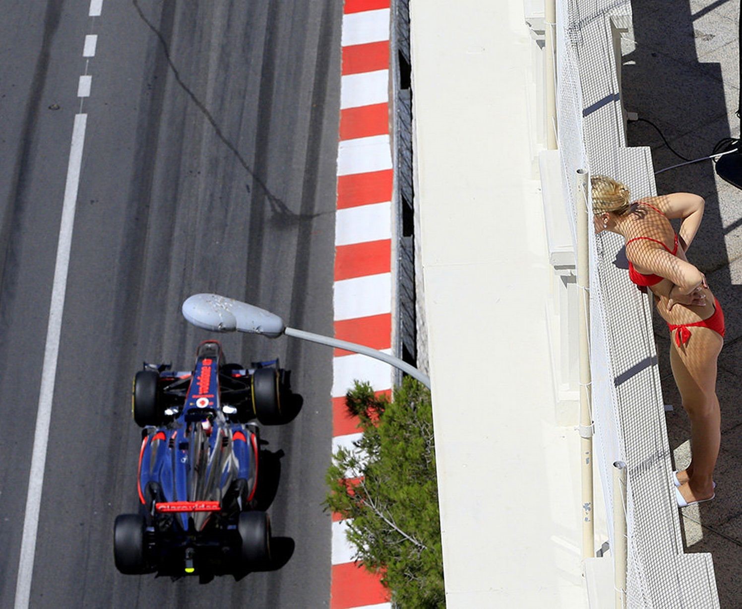 A woman watches the first practice session at the Circuit de Monaco. 