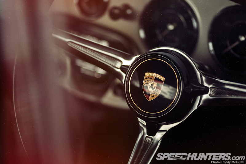 The steering wheel of a vintage Porsche.