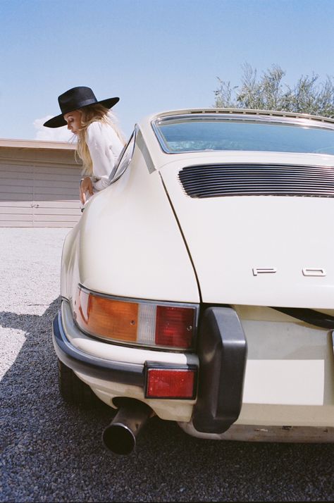 A girl in a withe Porsche.