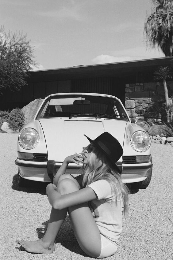 A girl and a withe Porsche.