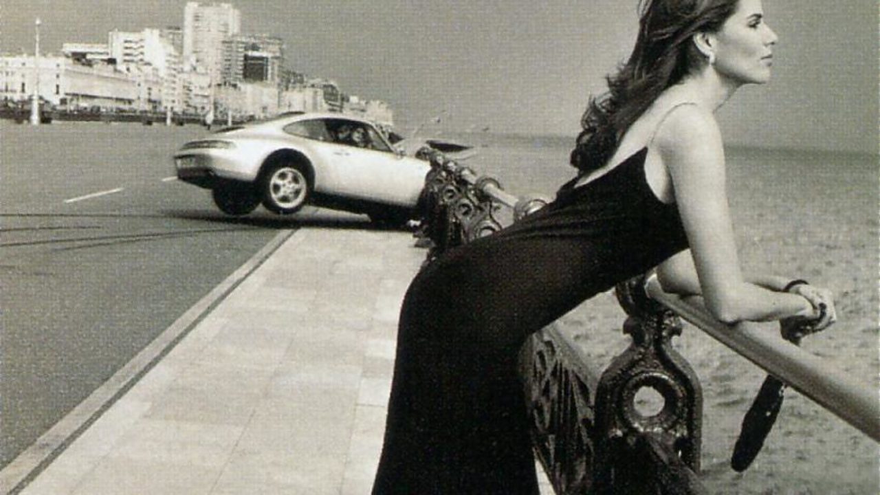 A girl and a Porsche 993 which is having an accident to look at her.