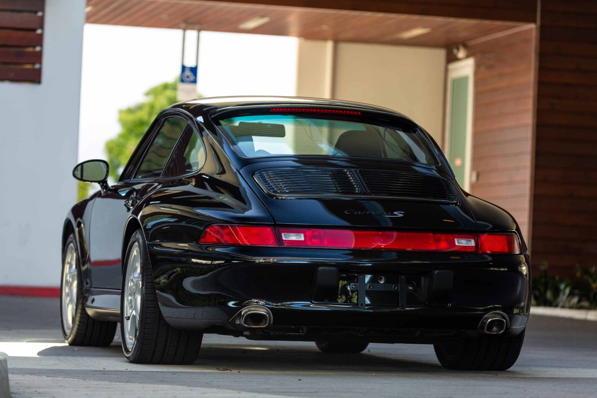 A 1997 black Porsche 993.