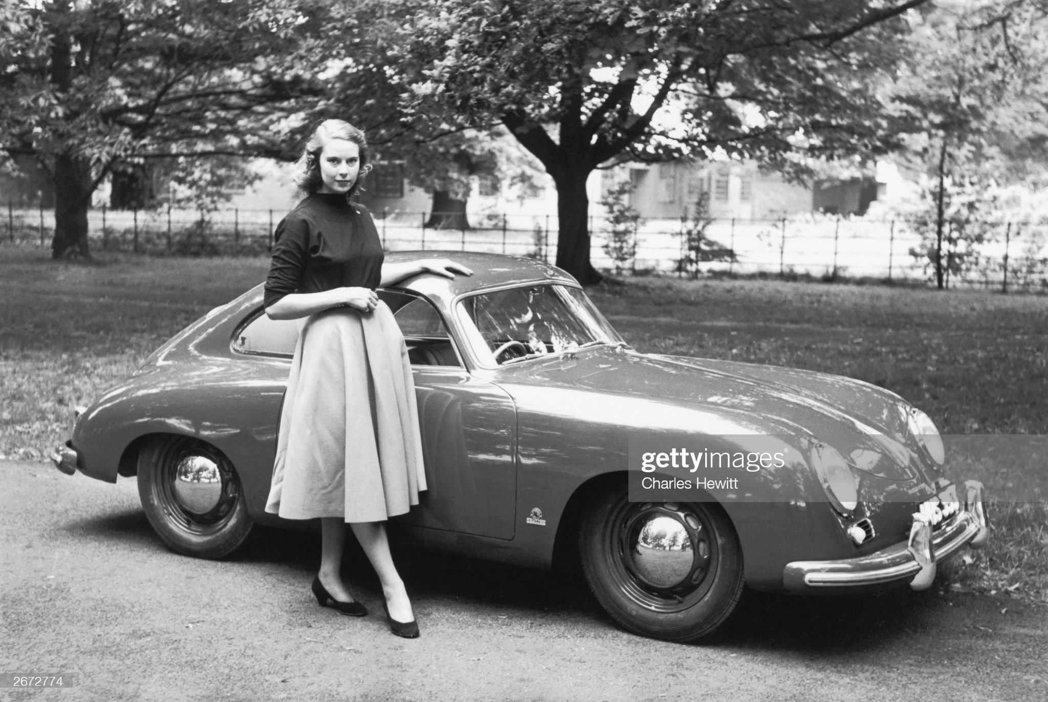 A woman and a Porsche coupe on October 23, 1954.