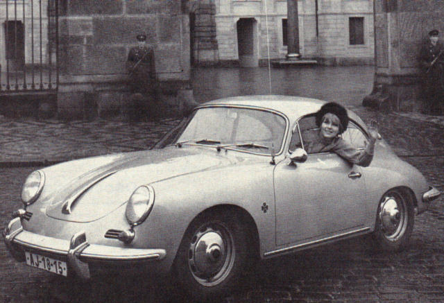 A woman in a Porsche 356.
