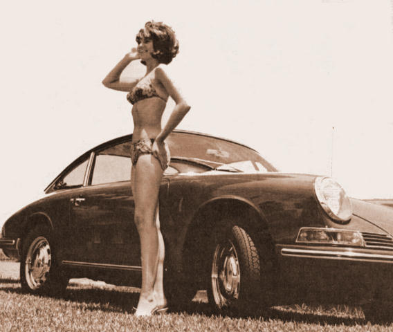A girl in a bikini and a black Porsche 911.