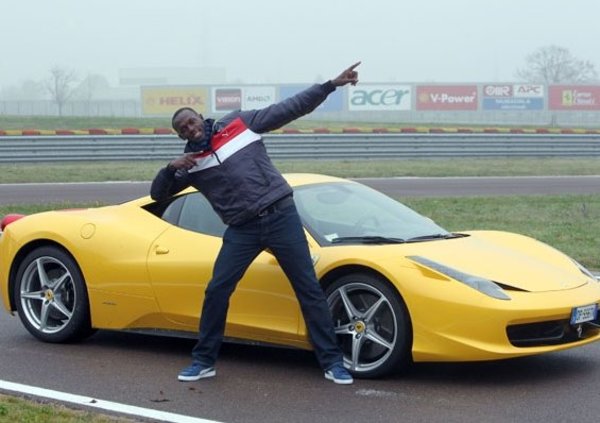Usain bolt with a red Ferrari