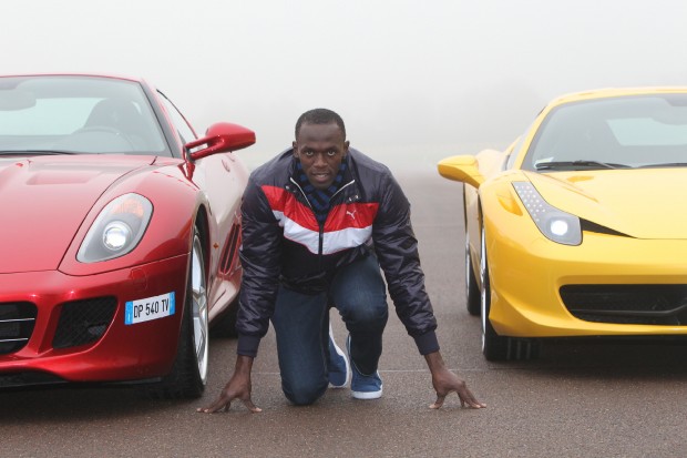 Usain bolt with two Ferraris