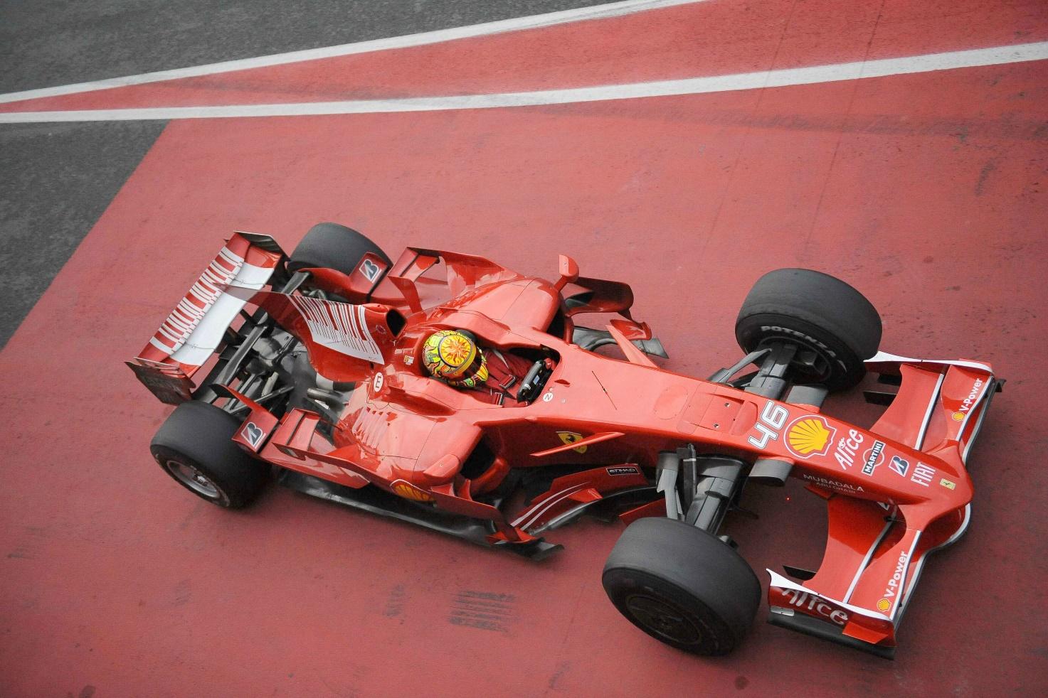 Valentino Rossi driving a Ferrari.