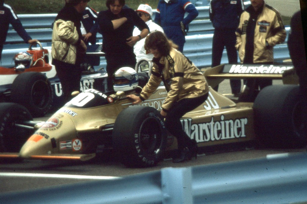 Jochen Mass being attended to by one of the Penthouse girls on the grid at Watkins Glen in 1980.